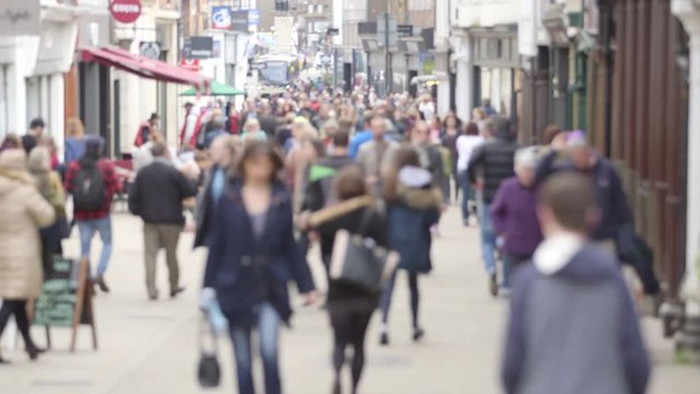 UK High street: A defocussed tilt shot of unidentifiable people walking on a busy British high street.