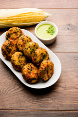 Crispy Corn Tikki, pakora/pakoda or pattice also known as cutlet. served with green chutney. Selective focus