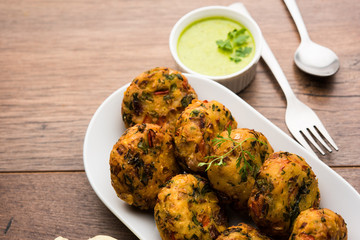 Crispy Corn Tikki, pakora/pakoda or pattice also known as cutlet. served with green chutney. Selective focus