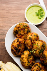 Crispy Corn Tikki, pakora/pakoda or pattice also known as cutlet. served with green chutney. Selective focus