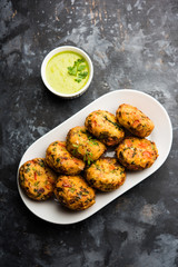 Crispy Corn Tikki, pakora/pakoda or pattice also known as cutlet. served with green chutney. Selective focus