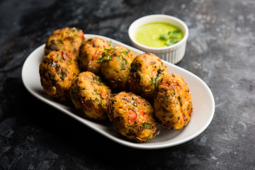 Crispy Corn Tikki, pakora/pakoda or pattice also known as cutlet. served with green chutney. Selective focus