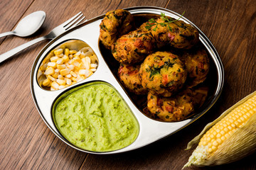 Crispy Corn Tikki, pakora/pakoda or pattice also known as cutlet. served with green chutney. Selective focus