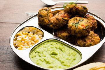 Crispy Corn Tikki, pakora/pakoda or pattice also known as cutlet. served with green chutney. Selective focus
