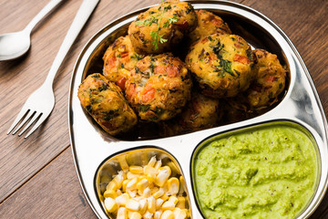 Crispy Corn Tikki, pakora/pakoda or pattice also known as cutlet. served with green chutney. Selective focus