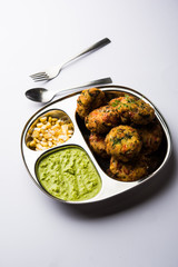 Crispy Corn Tikki, pakora/pakoda or pattice also known as cutlet. served with green chutney. Selective focus