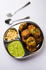 Crispy Corn Tikki, pakora/pakoda or pattice also known as cutlet. served with green chutney. Selective focus