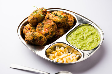 Crispy Corn Tikki, pakora/pakoda or pattice also known as cutlet. served with green chutney. Selective focus