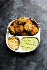 Crispy Corn Tikki, pakora/pakoda or pattice also known as cutlet. served with green chutney. Selective focus
