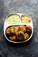Crispy Corn Tikki, pakora/pakoda or pattice also known as cutlet. served with green chutney. Selective focus