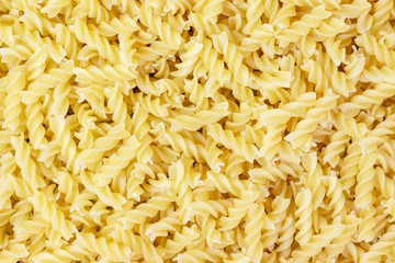 Italian pasta fusilli background. Closeup
