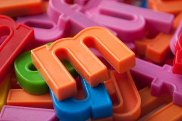 Naklejka premium closeup of colorful plastic letters on full frame