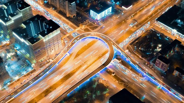 Beautiful timelapse of the big road junction with a lot of traffic on the night, view from above. Aerial shot of busy crossroad in Moscow center with a lot of traffic and glittering city lights.