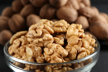bowl of walnut kernels on a dark background