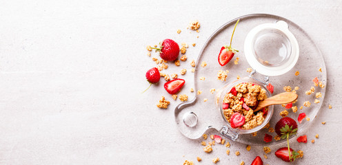 Obraz na płótnie Canvas Granola Cereal bar with Strawberries on the Gray Background in a glass jar. Muesli Breakfast. Healthy Food sweet dessert snack. Diet Nutrition Concept. Top View. Vegetarian food.Flat Lay.Copy space