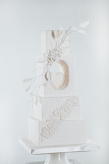 Beautiful wedding cake decorated with flowers. white wedding flower cake on the table.