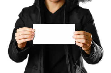 A man in a warm winter jacket holding a white leaflet. Blank paper. Close up. Isolated on white background