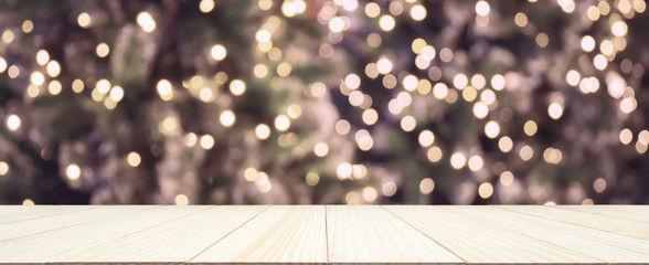 Empty wood table top with Abstract blur Christmas tree with decoration bokeh light background for...