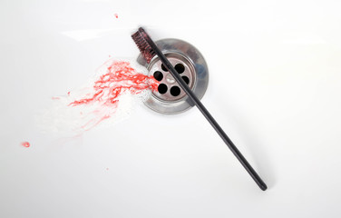 Toothpaste with blood in a ceramic sink. Bleeding gums. Close up