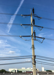 Concrete electric pole under the blue sky.