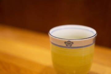 Hot green tea in ceramic cup in Japanese restaurant