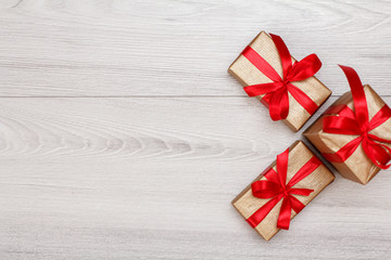 Three gift boxes on gray wooden background