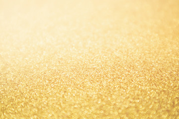 Obraz premium Abstract Gold glitter festive Christmas texture background blur with bokeh light