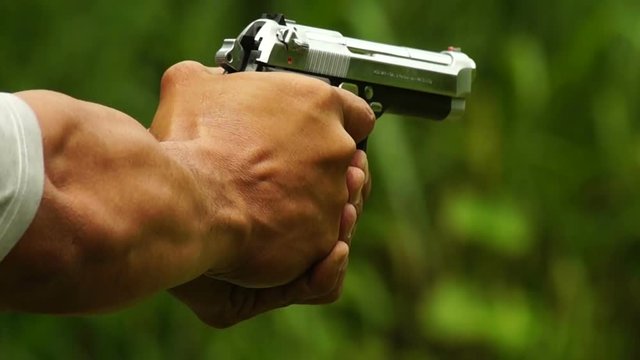 Hand Gun firing during practical shooting practice. close up
