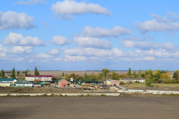 A view from above of a small Russian village. Rural landscape. Field and village. A semi-abandoned village