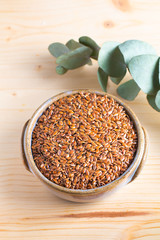 Healthy food concept Organic Flax seeds in ceramic bolw on wooden board with copy space