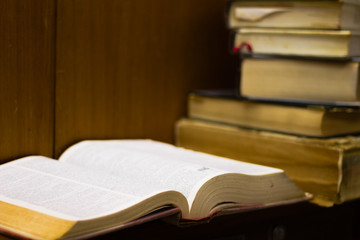 Open old book on a wooden book shelf 