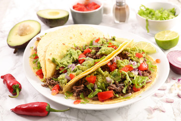 taco with beef, avocado and tomato