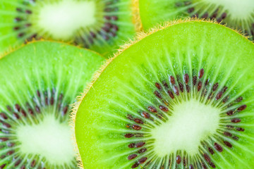 Fresh kiwi fruit slices closeup macro background
