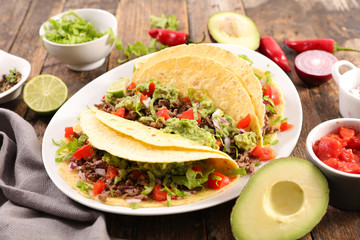 taco with beef, avocado and tomato