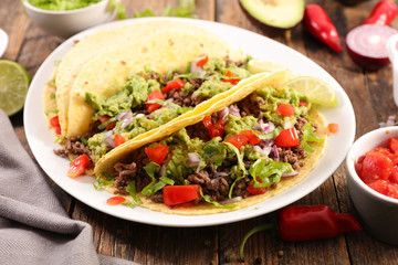 taco with beef, avocado and tomato