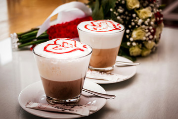 Two glasses of coffee decorated with hearts. Beverage in Valentine's Day_