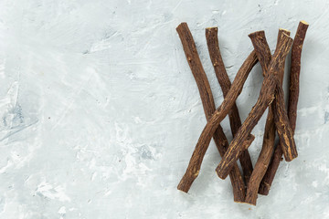 Powder and licorice root on the table - Glycyrrhiza glabra