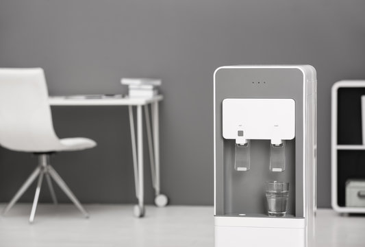 Modern water cooler in stylish office interior