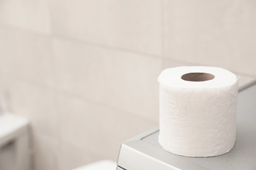 Toilet paper roll on table in bathroom. Space for text