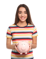 Fototapeta na wymiar Portrait of young woman with piggy bank on white background