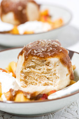 portioned cake with cream and fruit, vertical closeup