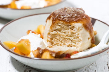 portioned cake with cream and fruit