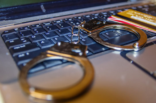 handcuffs, card on a laptop