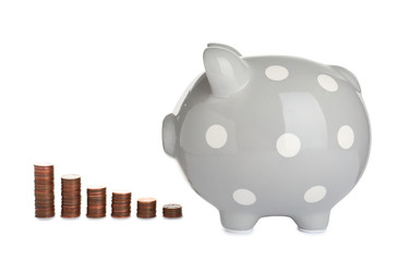 Ceramic piggy bank and many coins on white background