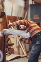 Carpenter working on wooden forcola for venetian gondola