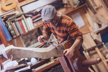 Carpenter working on wooden forcola for venetian gondola © guerrieroale
