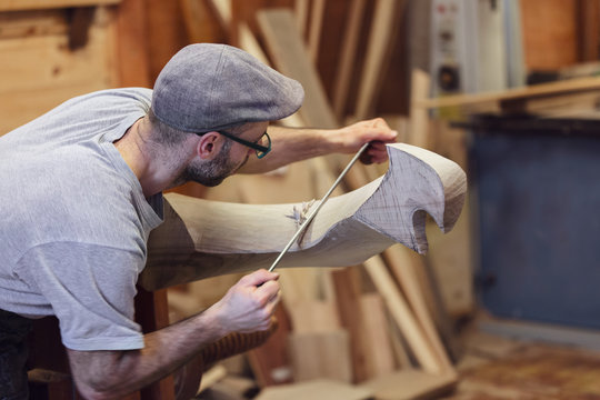 Carpenter working on wooden forcola for venetian gondola