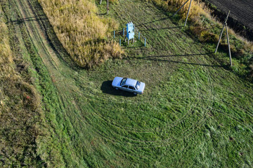 Top view of a silver car standing on the lawn. One Flew Over the Car