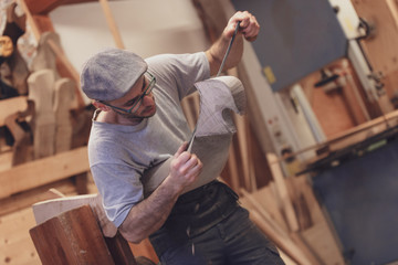 Carpenter working on wooden forcola for venetian gondola © guerrieroale