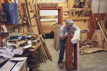 Carpenter working on wooden forcola for venetian gondola